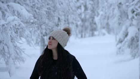 girl exploring snowy winter wonderland in lapland, finland, arctic circle