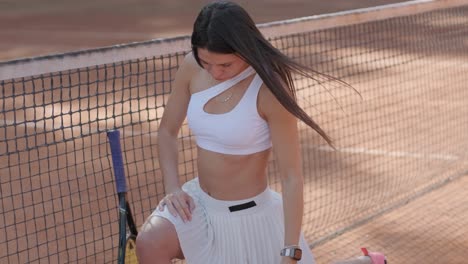 a young woman practicing tennis on an outdoor court with a coach. the coach provides guidance as the player works on her technique, perfecting her strokes in an athletic training session.