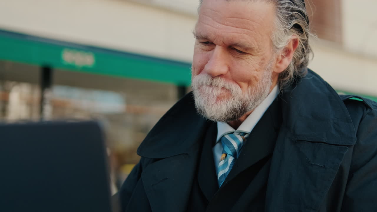 Businessman Enjoys Orange Juice at Outdoor Cafe