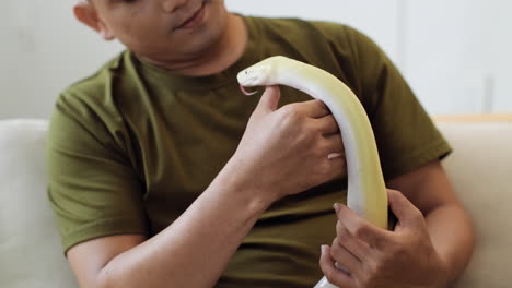 man with snake indoors