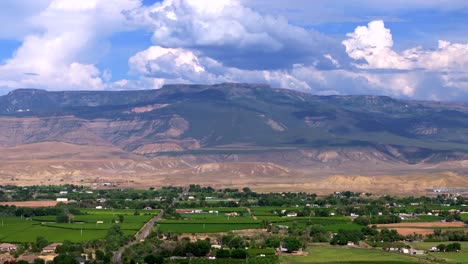 grand mesa grand junction aerial drone afternoon cloudy colorado river summer blue sky wine vineyards parachute fruitvale mt garfield western close delta downtown main street circle left motion