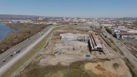 wide aerial footage of a construction site next to i-24 highway in chattanooga, tn.