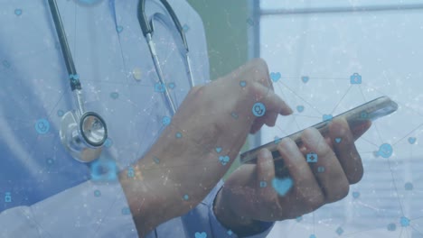 Network-of-digital-icons-against-mid-section-of-male-doctor-using-smartphone-at-hospital