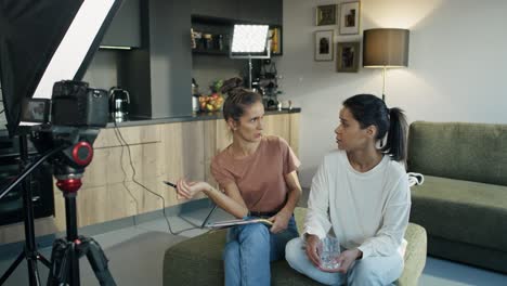 Two-female-women-recording-a-movie-from-home