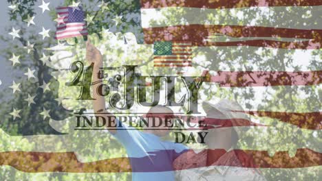 independence day text banner against african american soldier in uniform carrying son waving flag