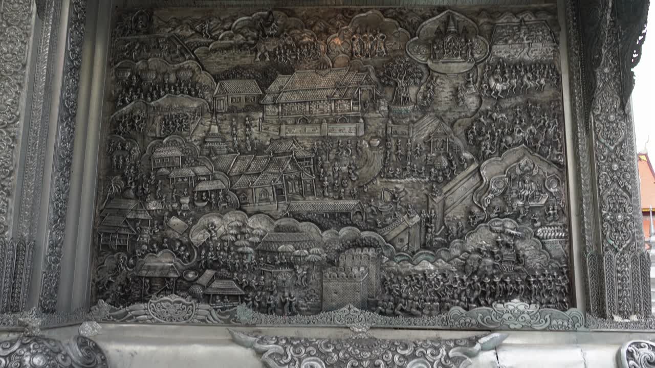 Thailand,Chiang Mai,Tilt up slowly over the amazing silver reliefs,outside of the Famous Silver Temple,Wat Si Supan. Amazing silversmithing art.