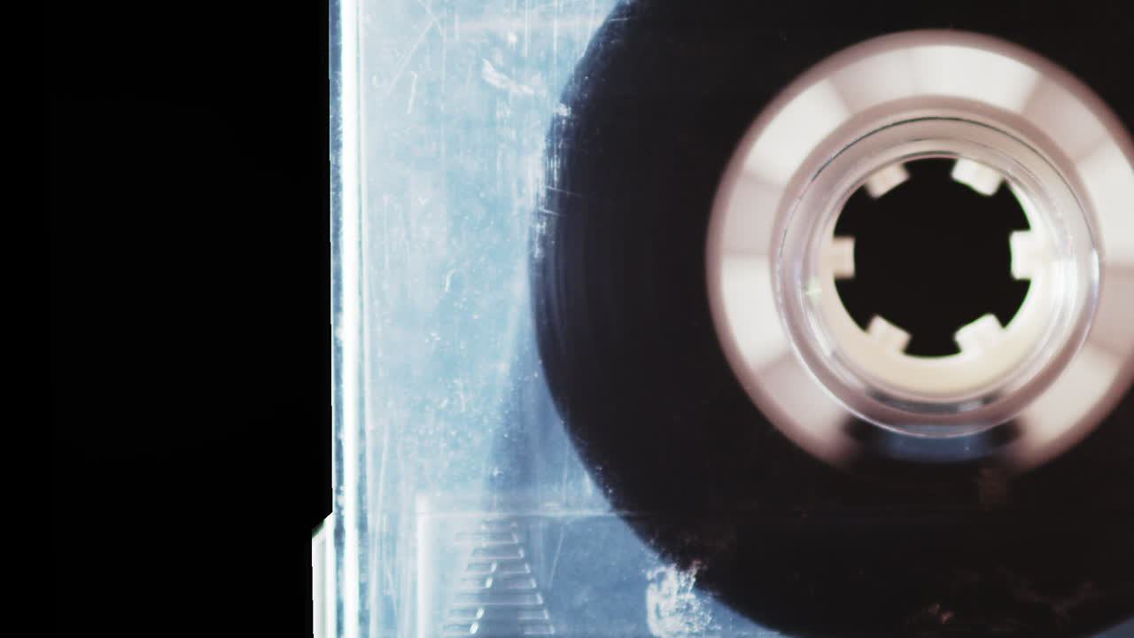 Cassette tape wheel gradually picking up speed to fast forward, macro