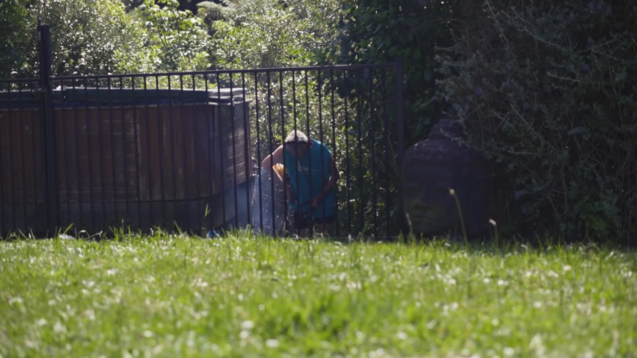 Man Cutting Grown Green Grass In The Garden Using Brush Cutter