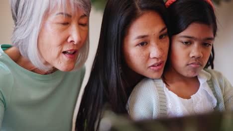 Face,-tablet-and-an-asian-family-in-the-living