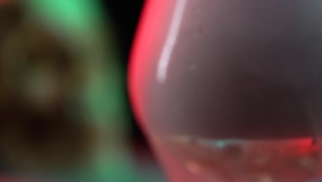 closeup of skull near blurred view glass with smoke and the effect of dry ice on black background