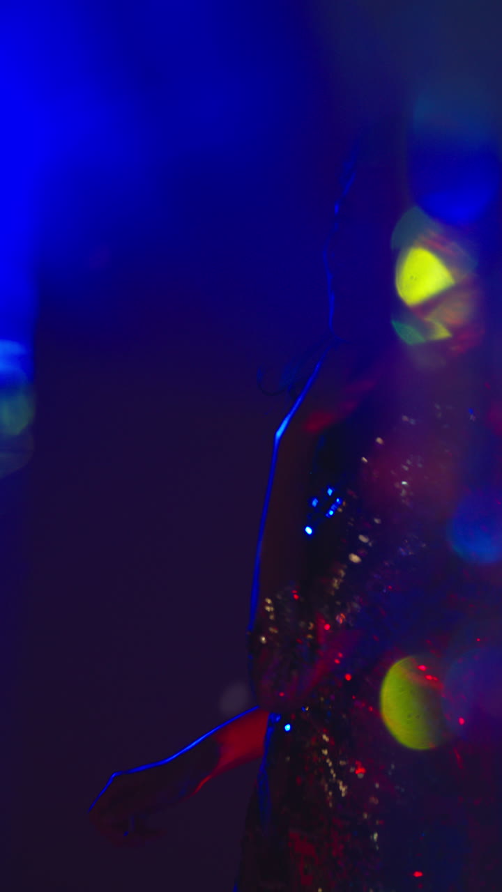 Vertical Video Of Woman In Nightclub Bar Or Disco Dancing With Sparkling Lights In Background