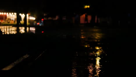 beautiful background with rainy night city. the rain drips on the puddles of the night city.