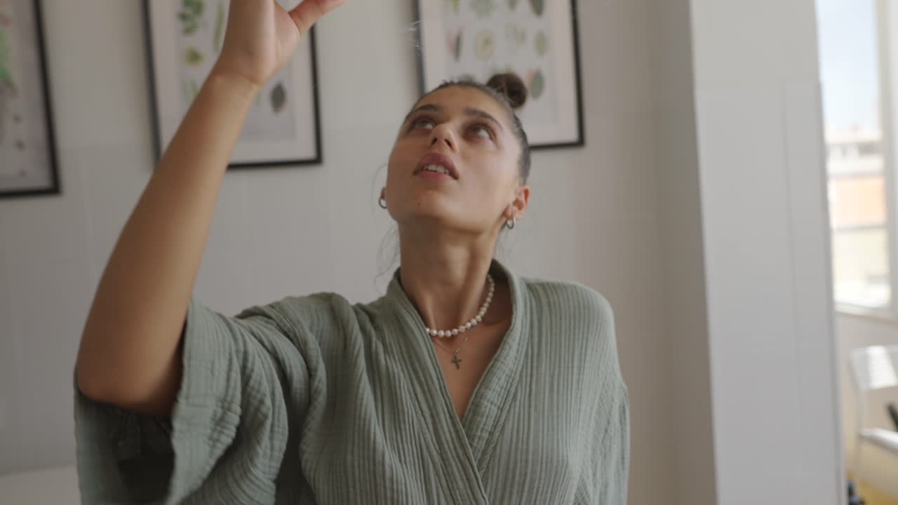 Woman holding burning incense stick