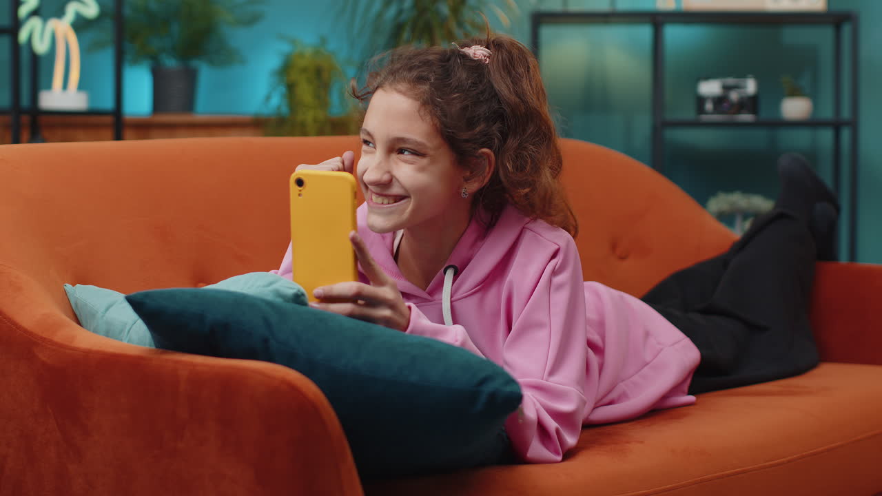 School girl use mobile smartphone celebrate success win triumph victory positive test exam results