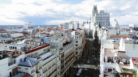 aerial madrid skyline panorama with office building and car traffic on gran via street, spain. vast areas of populous residential quarters