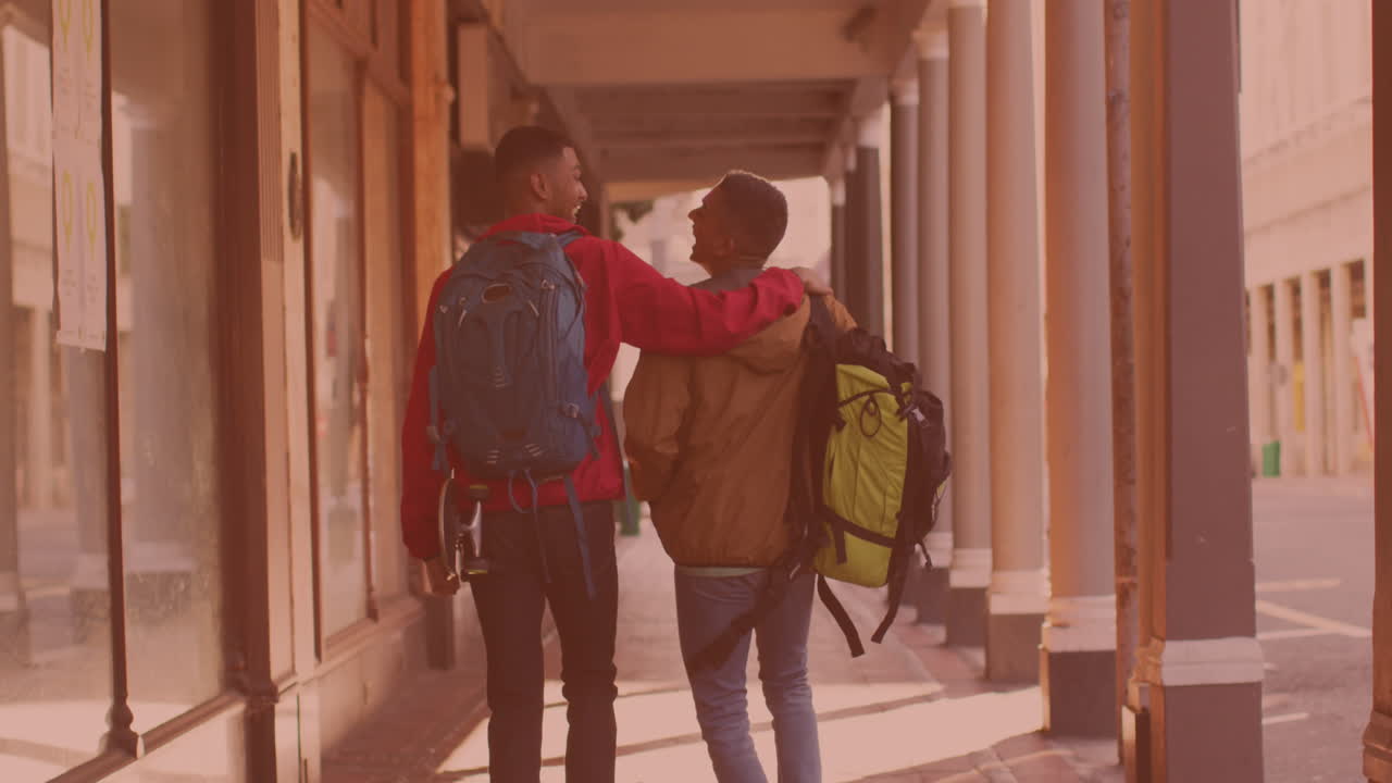 Rear view of two african american men walking and laughing together