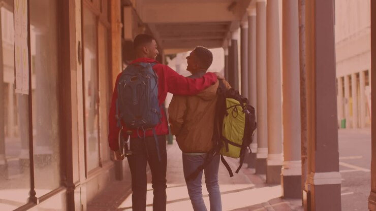 Vista posteriore di due uomini afroamericani che camminano e ridono insieme