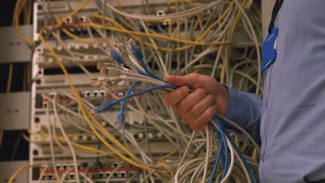 technician holding bunch of cables