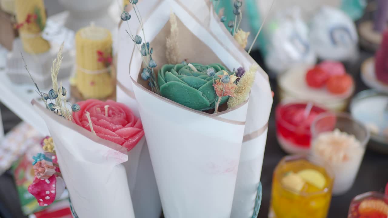 Handmade Candles and Flower Bouquets for Sale at a Market