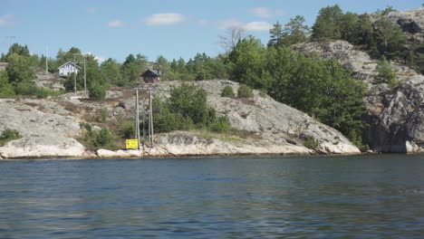 Remote-Norwegian-island,-viewed-from-boat-on-water