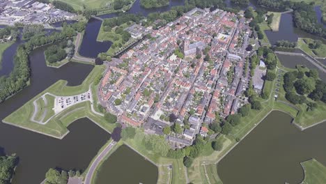 a drone shot panning up, of a historically dutch fortress called naarden, in the netherlands