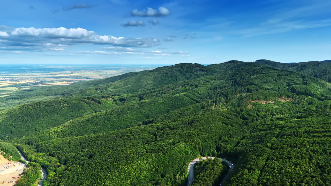 Green landscape, blue sky. A sweeping view of verdant hills under a bright blue sky, showcasing the beauty of nature in a tranquil setting