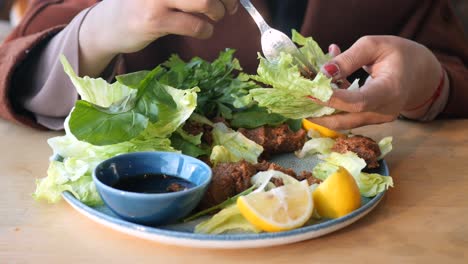 woman eating a plate of turkish food