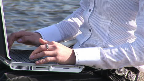 young attractive blonde woman on laptop outdoors