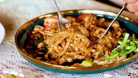 delicious shrimp pad thai being served and enjoyed