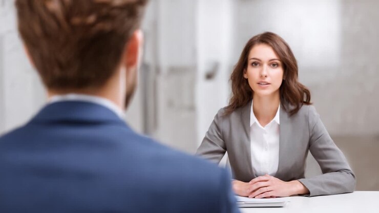 A Professional Conversation: Two Individuals Engaged in a Business Discussion in a Modern Office Setting, Focusing on Dialogue and Body Language for Effective Communication