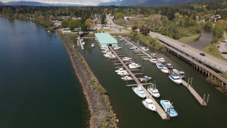 Aerial-View-of-Boats-Docked-at-Small-Marina-Docks,-Port-Alberni-in-Vancouver-Island,-British-Columbia-Canada