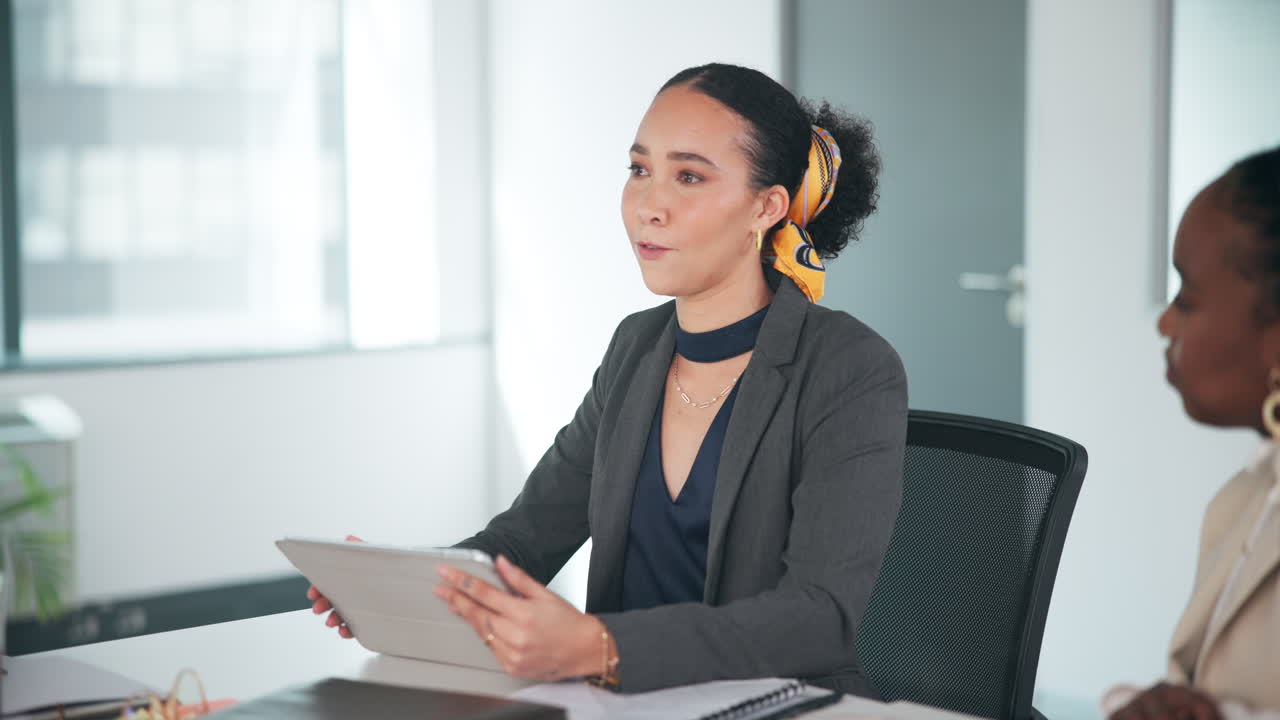 Business meeting with women using a tablet in an office