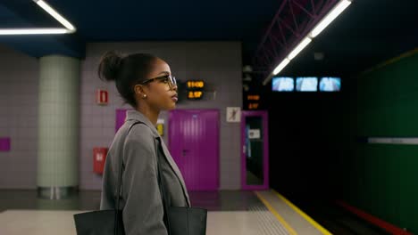 businesswoman waiting at a subway station