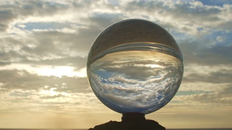 magic sunset view on the beach in a crystal ball.