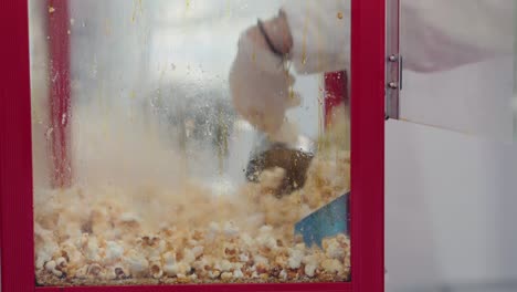 popped kernels burst in a red popcorn machine, a blur of snack-time excitement