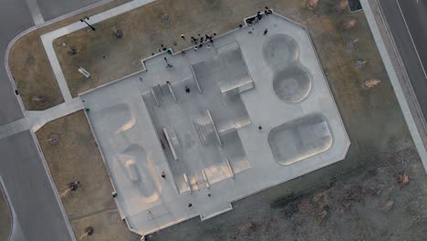 aerial over skate park and riders, top down slow rotating view