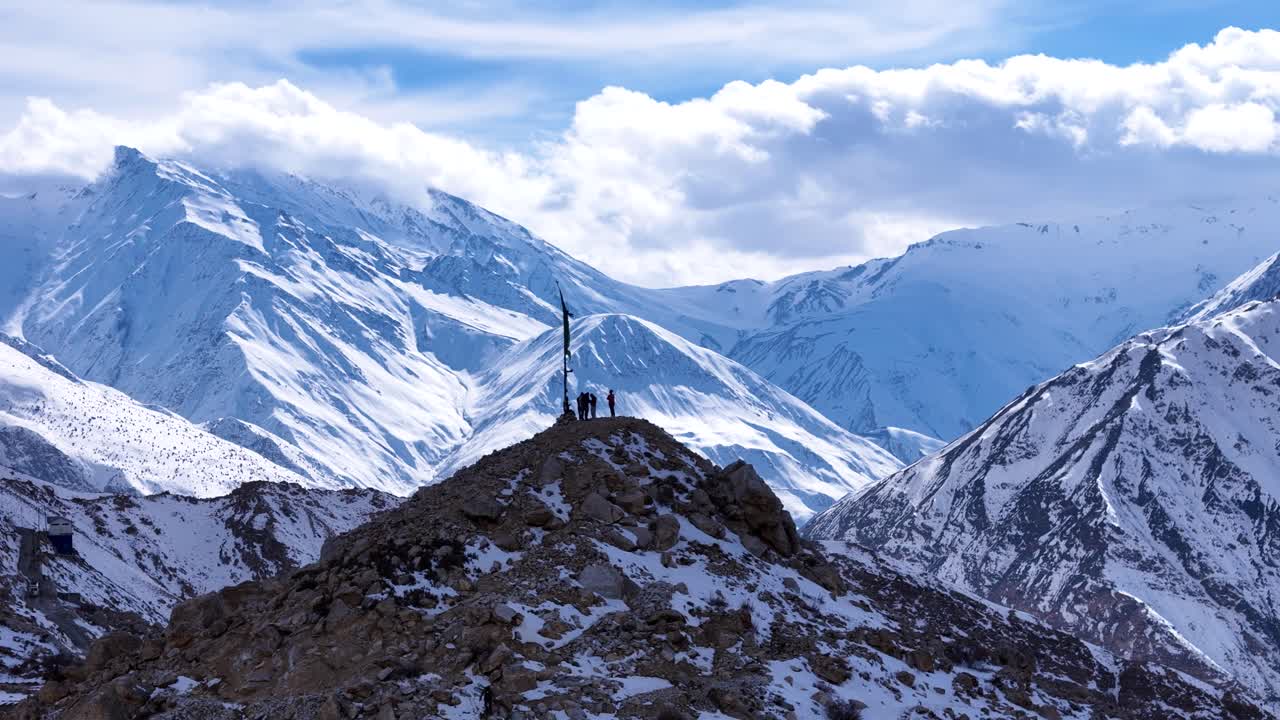 Snow-Capped Mountains with People on a Summit