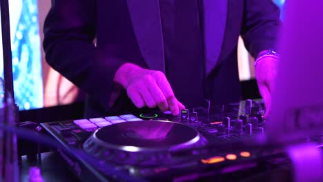 dj adjusts the console playing music in the nightclub