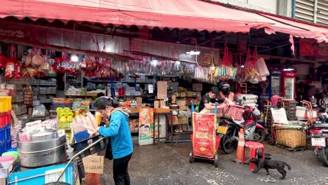 worker unloads supplies at a busy market street