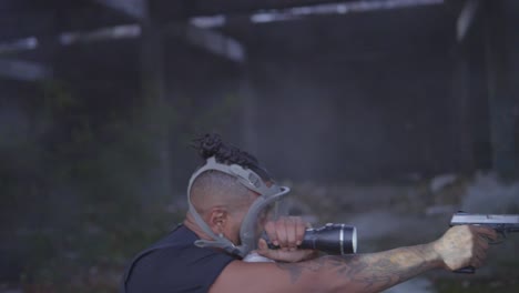 a black male officer scans the smokey ruins with his gun out and a search light