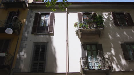 a close up shot of an old building facade with balconies and windows in the city