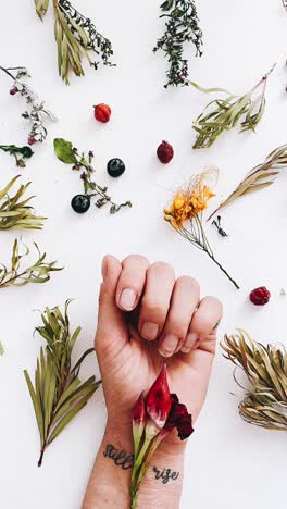 Hand with 'Still Rise' Tattoo and Floral Arrangement