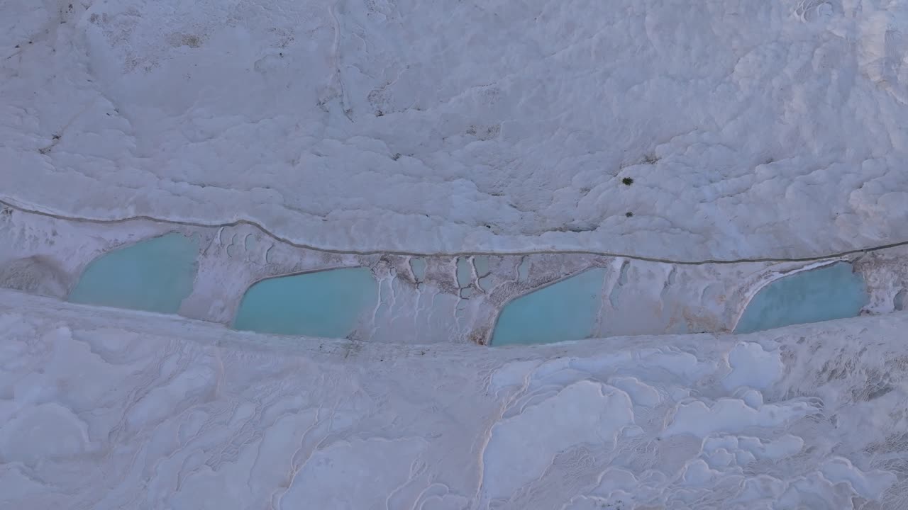 Sunrise illuminating Pamukkale limestone terraces, Turkey