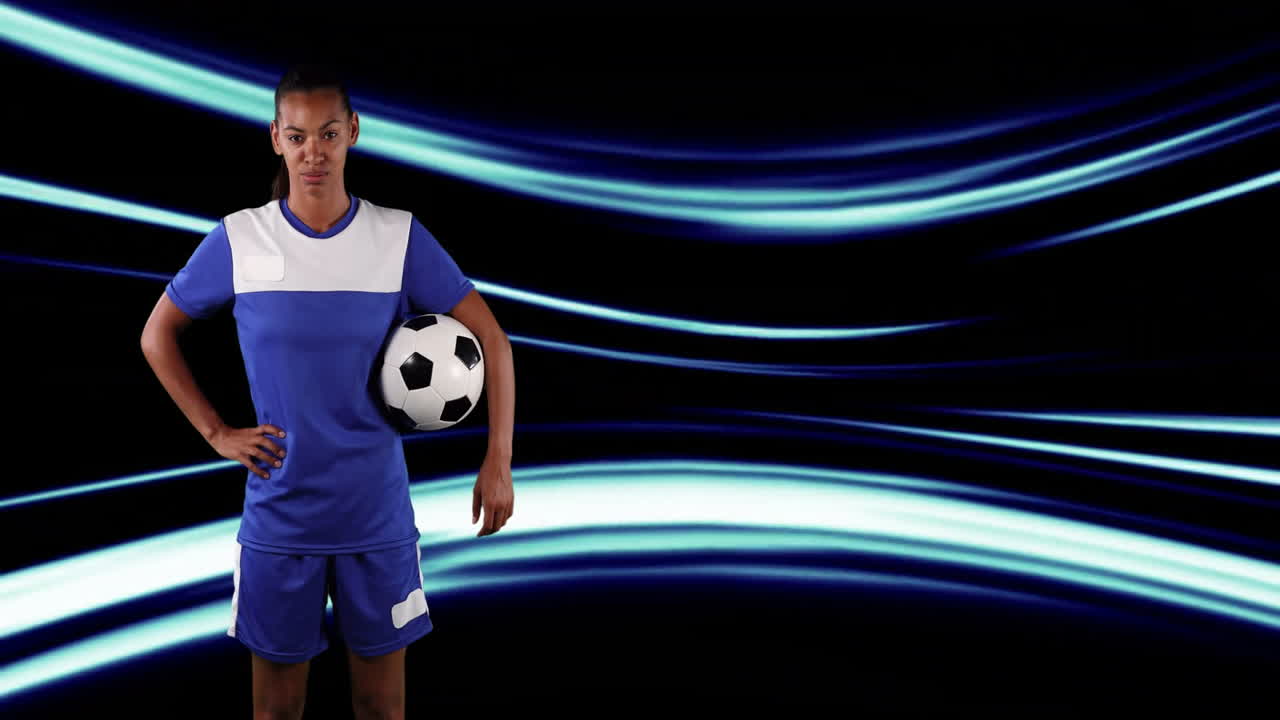 Holding soccer ball, athlete standing over blue light streaks animation
