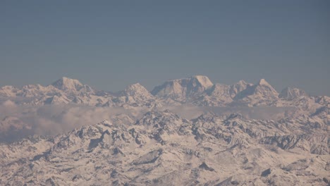 scenic aerial flight over the worlds largest mountains, the himalayas with views of mount everest and jagged snowcapped peaks