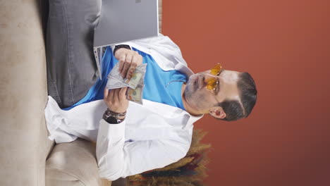 Vertical-video-of-Man-looking-at-laptop-counting-money.