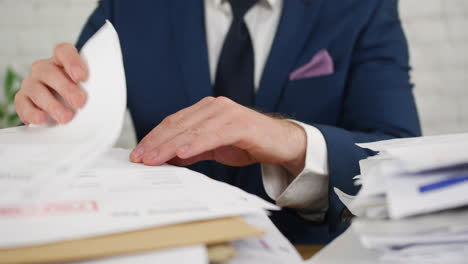 a man sorting paperwork in an office