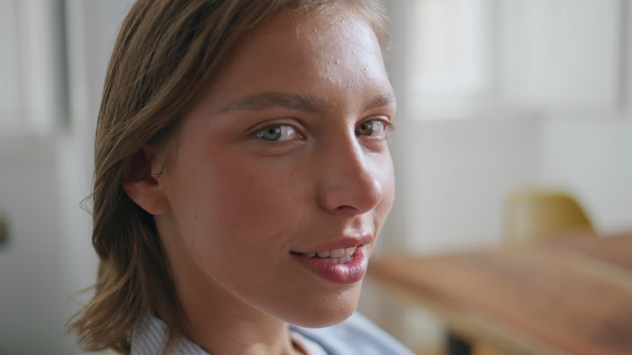 Serene lady looking camera in home interior. Portrait young woman