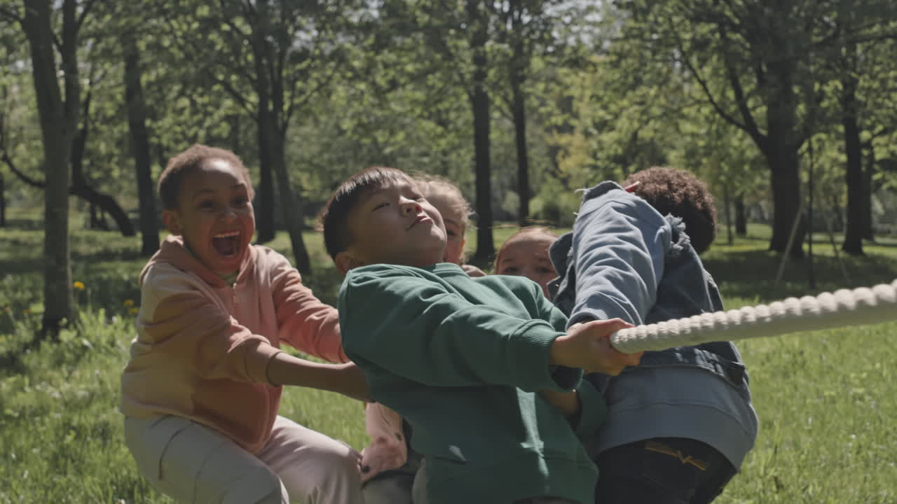 Kids playing tug of war in the park