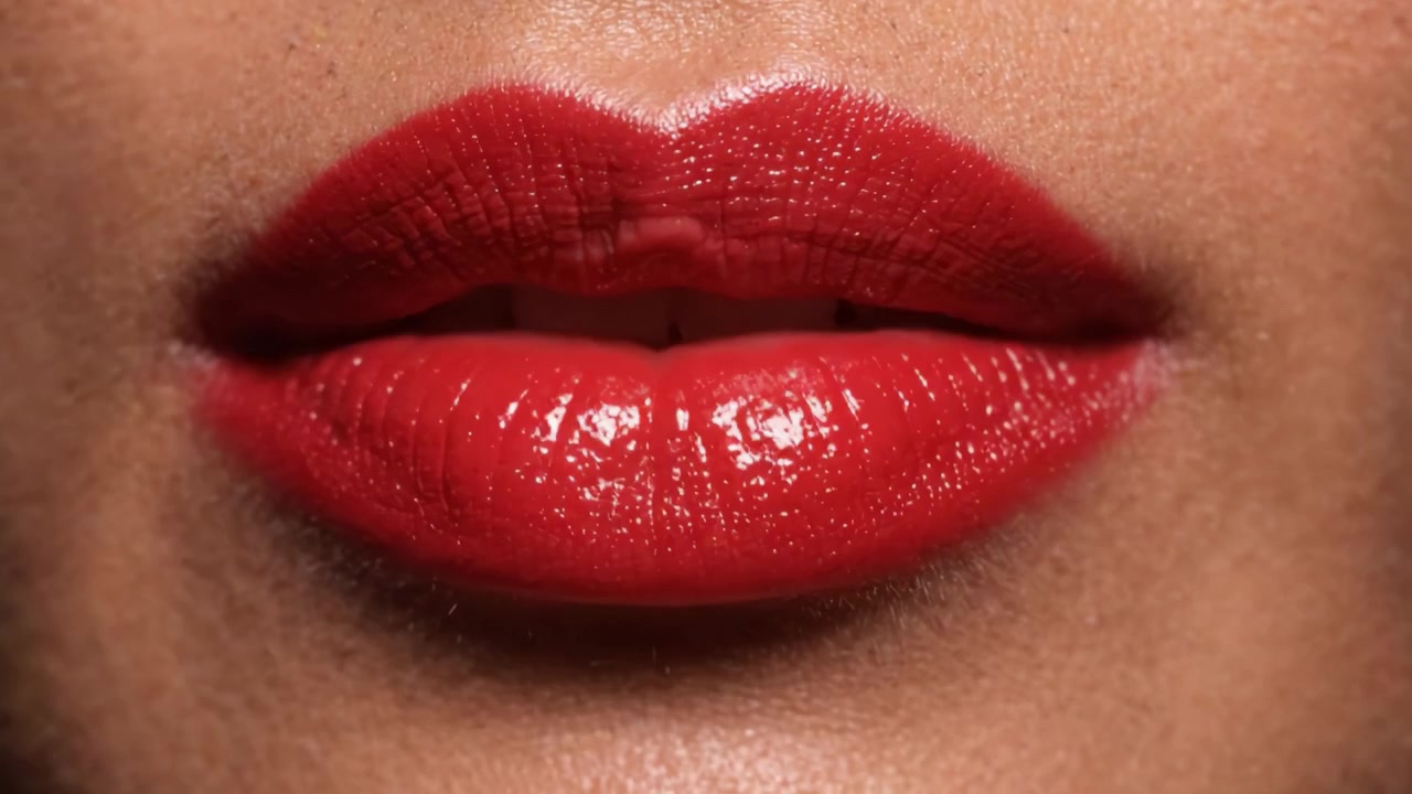 A Close-Up View of Glowing Red Lips, Highlighting Their Texture, Shine, and Vibrancy, Perfect for Makeup and Beauty Enthusiasts in Captivating Detail